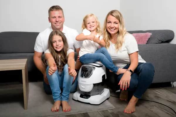 Familie mit dem Wasserstaubsauger nach der Teppichreinigung